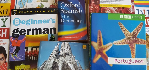 Different beginner's language books laid out. Language learning for native English speakers.